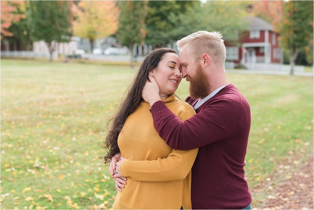 Couple embraces for fall portrait, Port Gamble, Washington